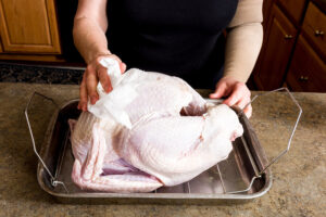 woman prepares a turkey