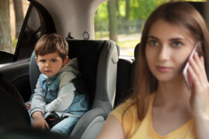distracted mother driving son in car