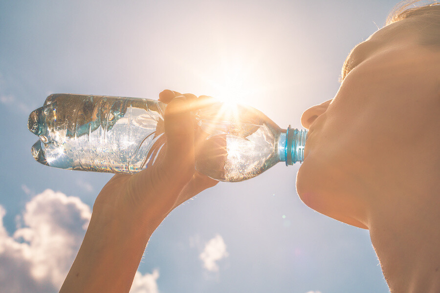 Woman drinking water in heat wave