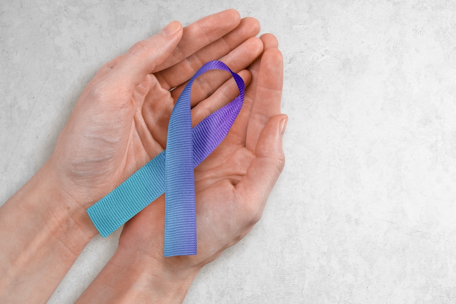 hand holding suicide awareness ribbon