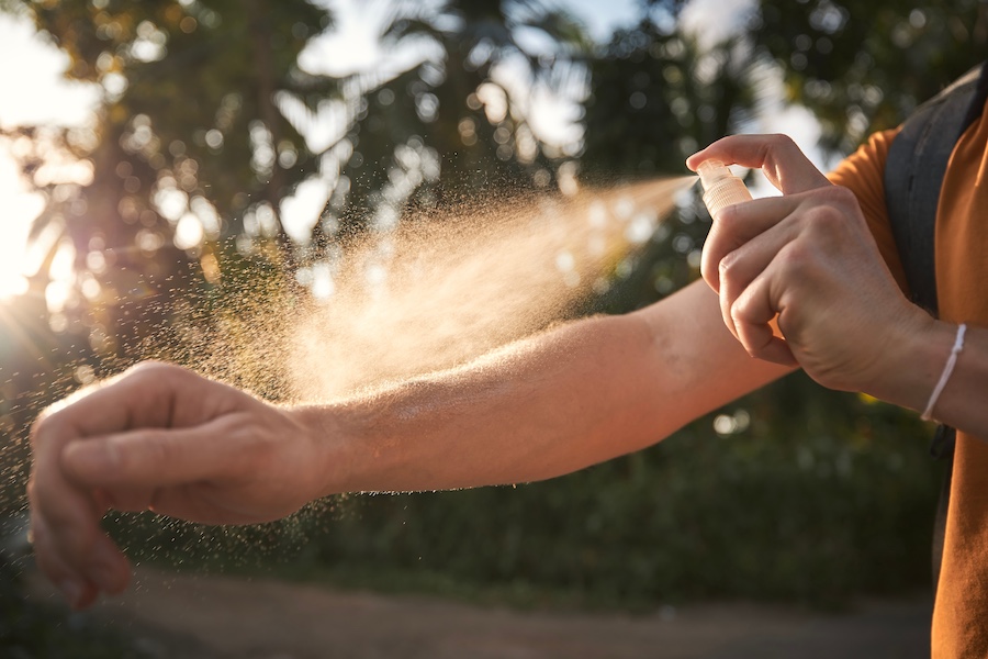 Man applying insect repellent on his arm