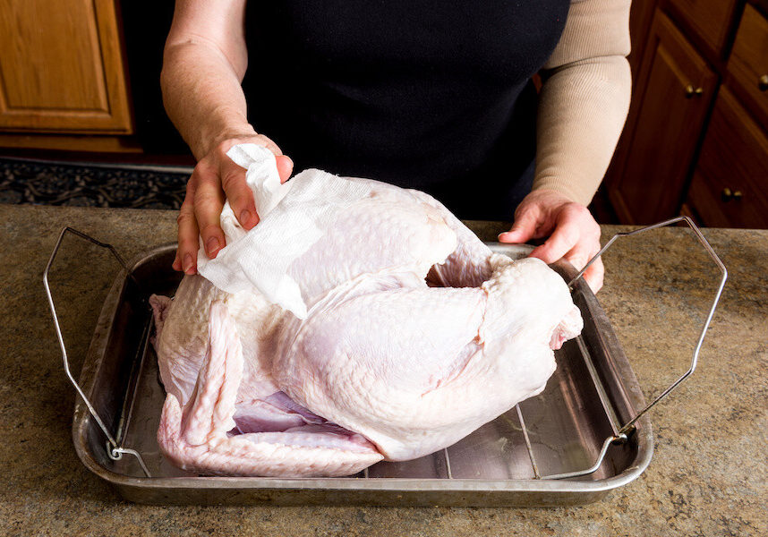 woman prepares a turkey