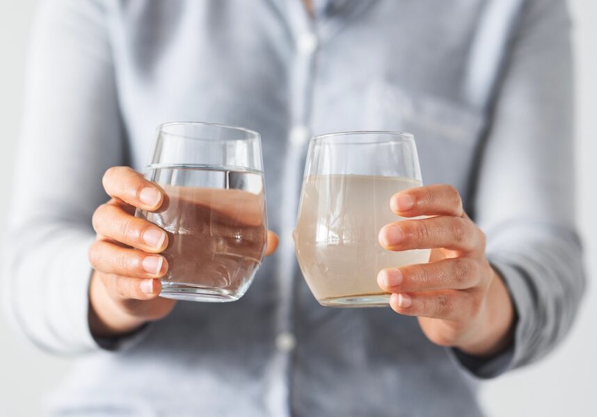 Woman holding clean and dirty water
