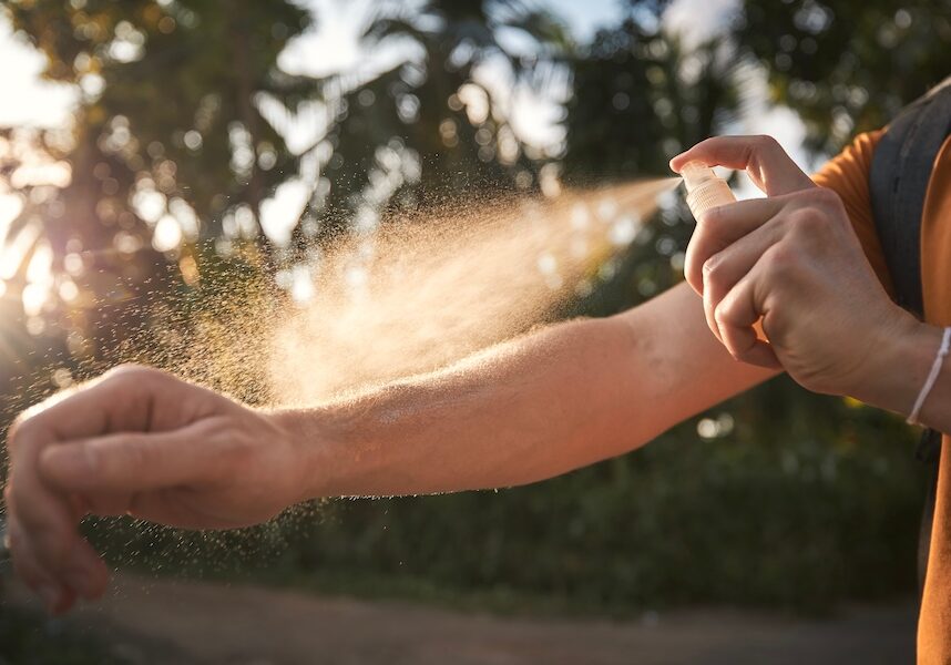 Man applying insect repellent on his arm