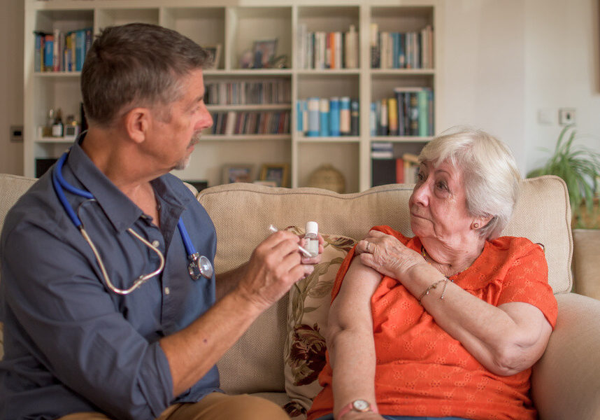 woman receiving vaccine at home