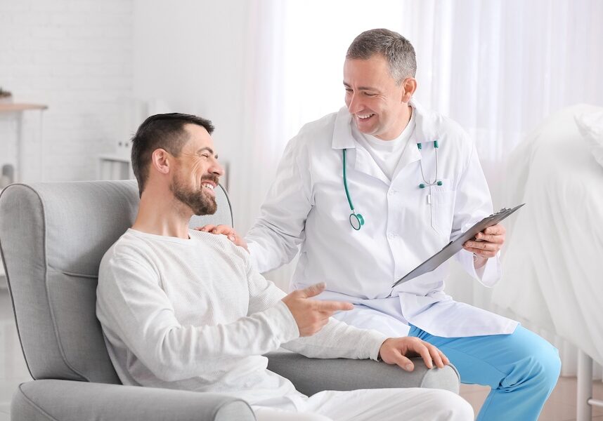 Doctor and man talking about colonoscopy options.