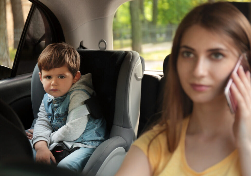 distracted mother driving son in car