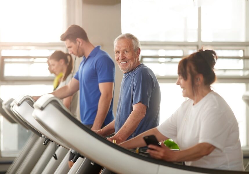 Older man walking on a treadmill.