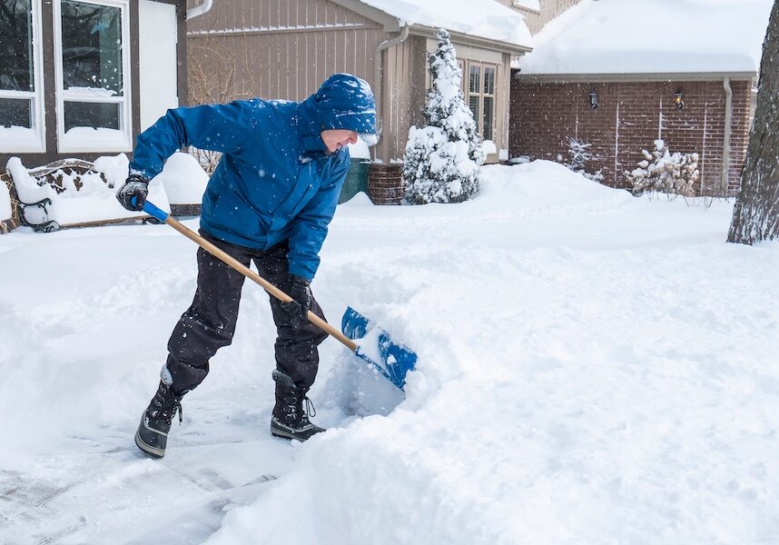 man shoveling heavy snow