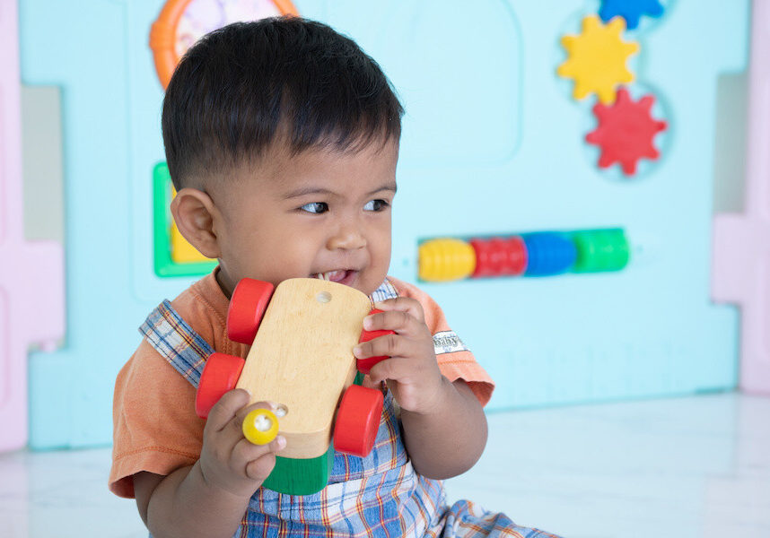 child chewing on toy